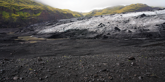 This glacier has ground its way through a lava field and then retreated, exposing the black volcanic rock below. You can also...